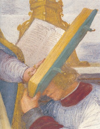 Un chierico regge il libro da cui legge il vescovo Machilla