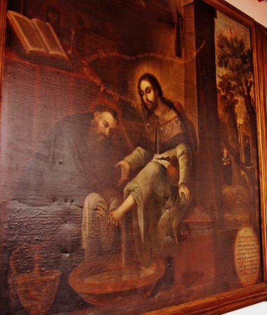 Agostino lava i piedi al Cristo pellegrino